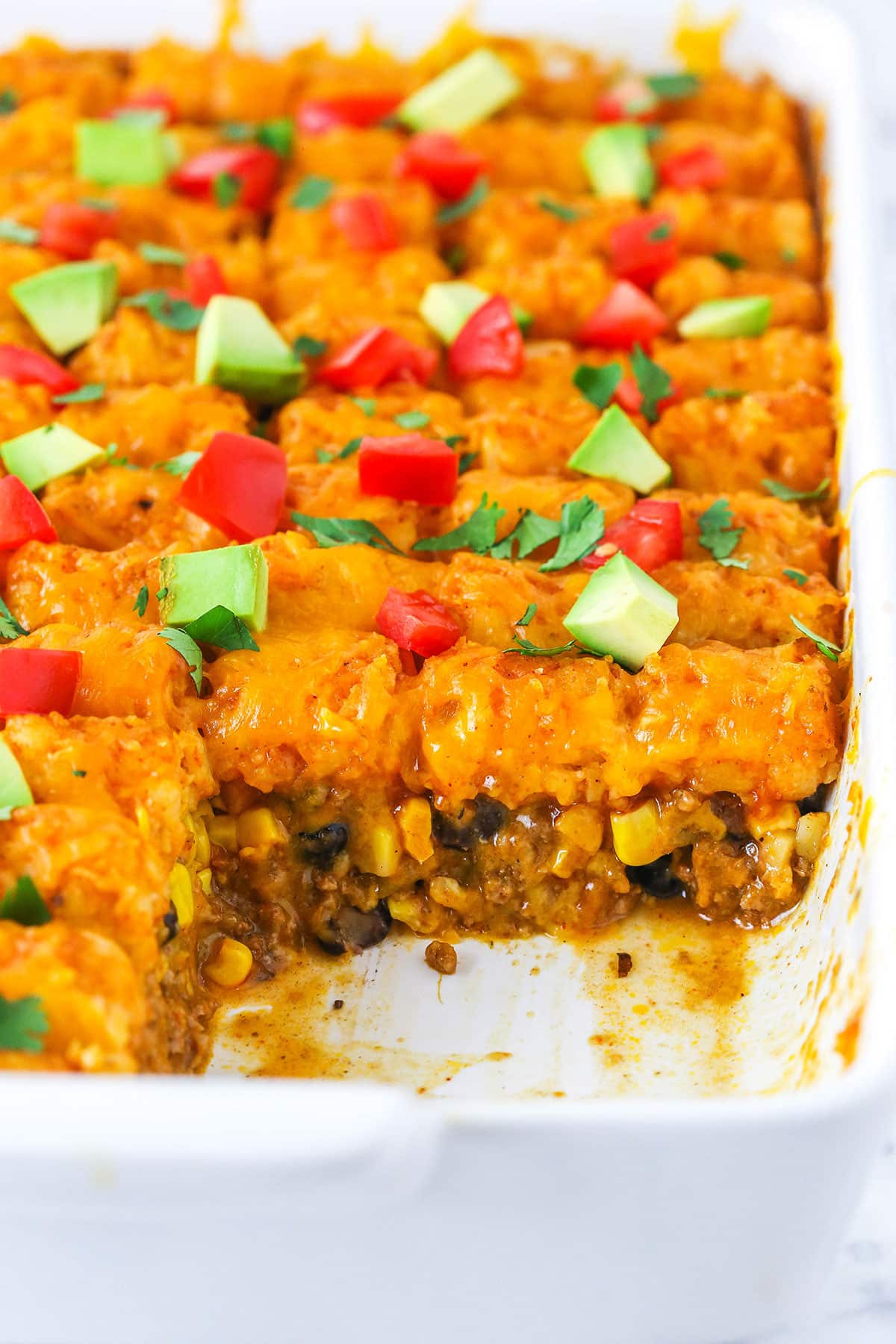 Taco Tater Tot Casserole with a serving removed in a white platter