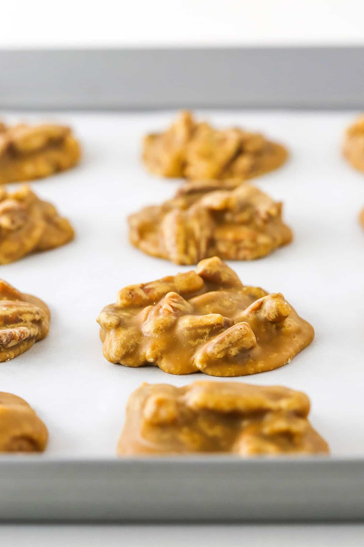 These are seriously the BEST Southern Praline Pecans! With the amazing flavor of brown sugar and butter, these are pure heaven! A little bit candy and a little bit cookie, they melt right in your mouth! Southern Pecan Pralines spread evenly and baked on a cookie sheet