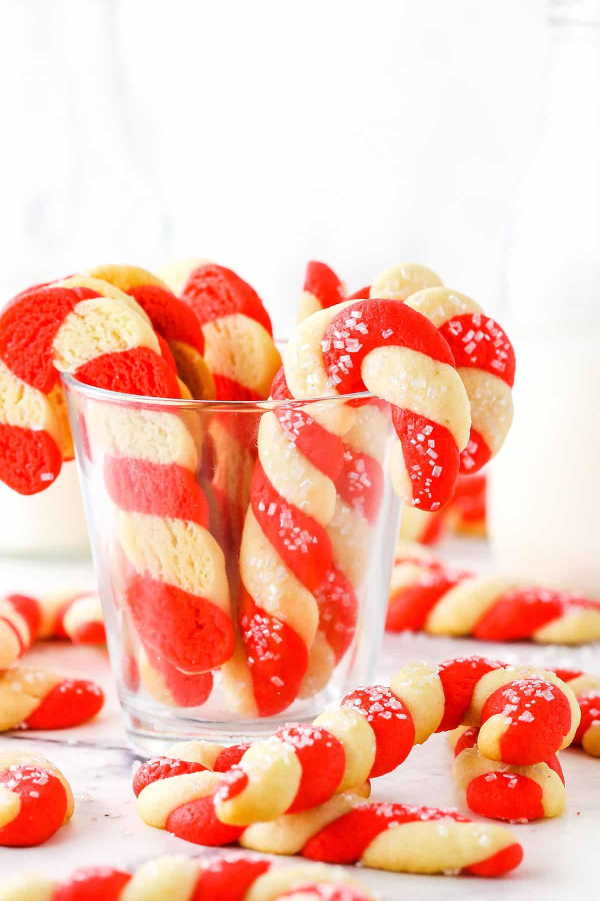 Red and white Candy Cane Cookies in a clear glass