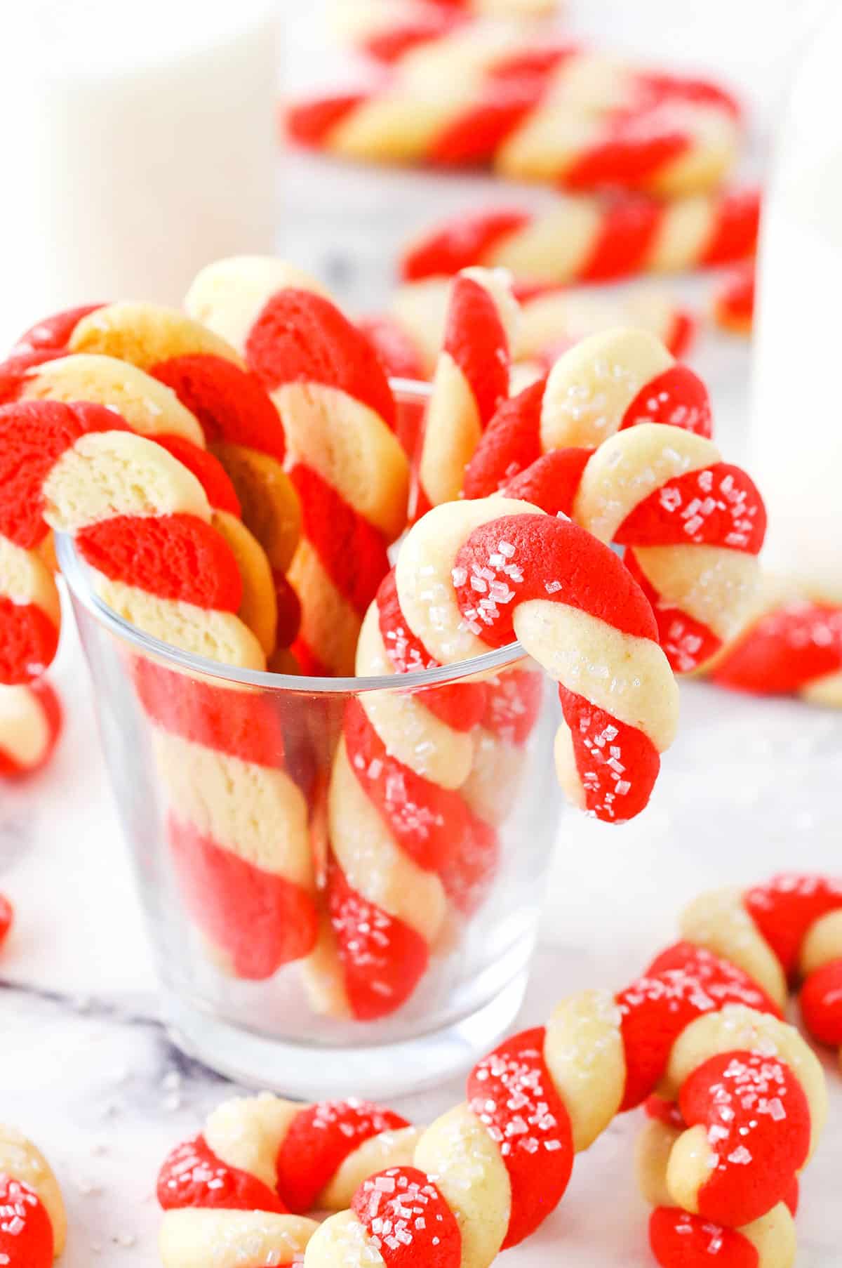 Red and white Candy Cane Cookies in a clear glass