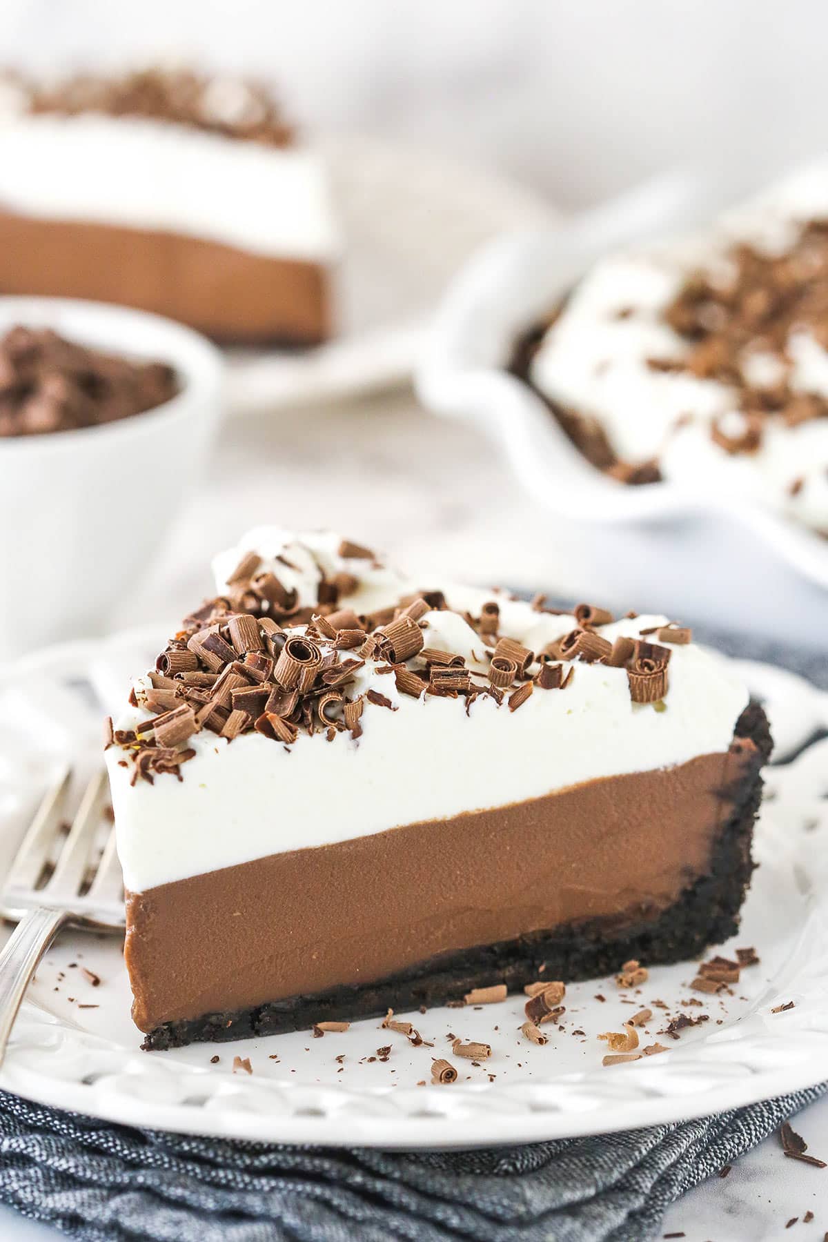 Chocolate cream pie on a plate with a fork.