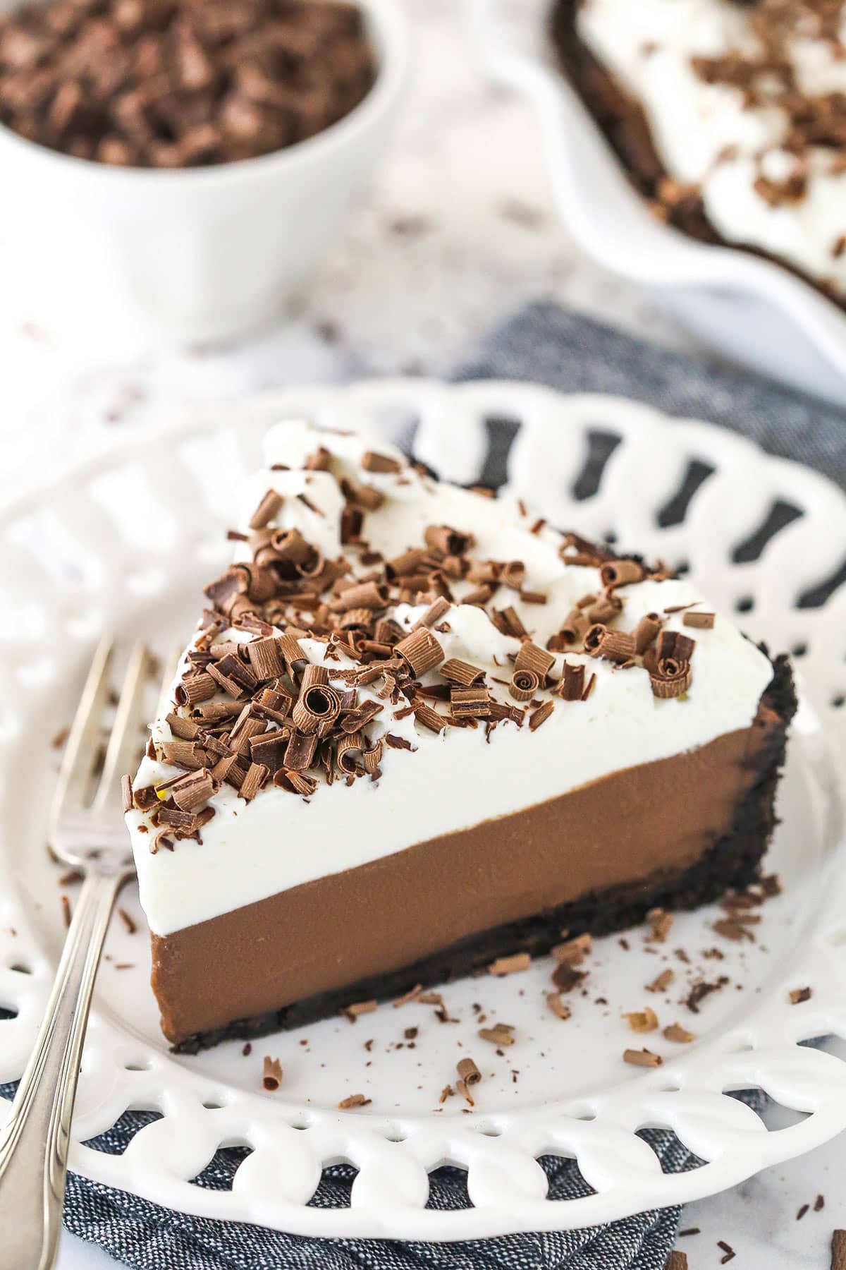 Chocolate cream pie on a plate with a fork.