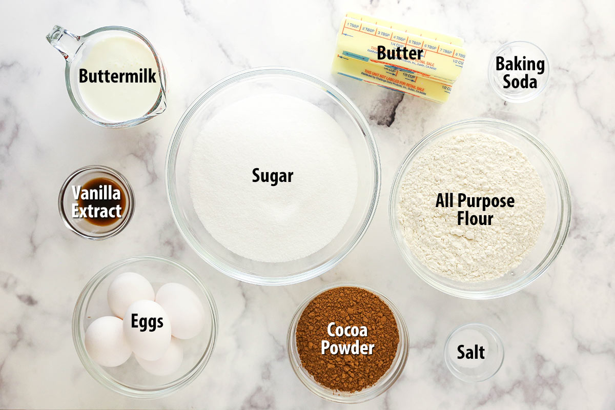 Ingredients for chocolate pound cake separated into bowls and labeled.