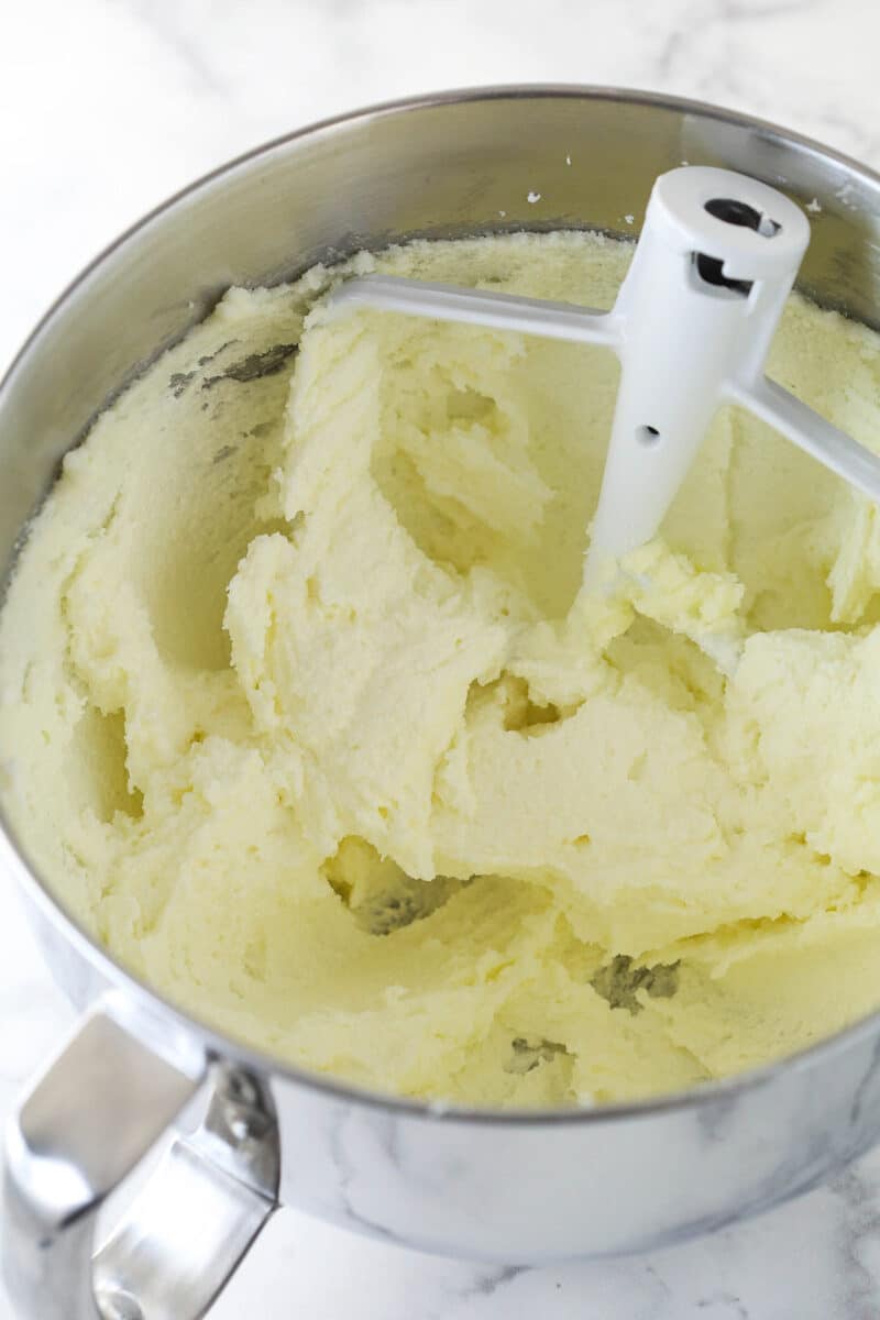 Creaming together butter and sugar in a mixing bowl.