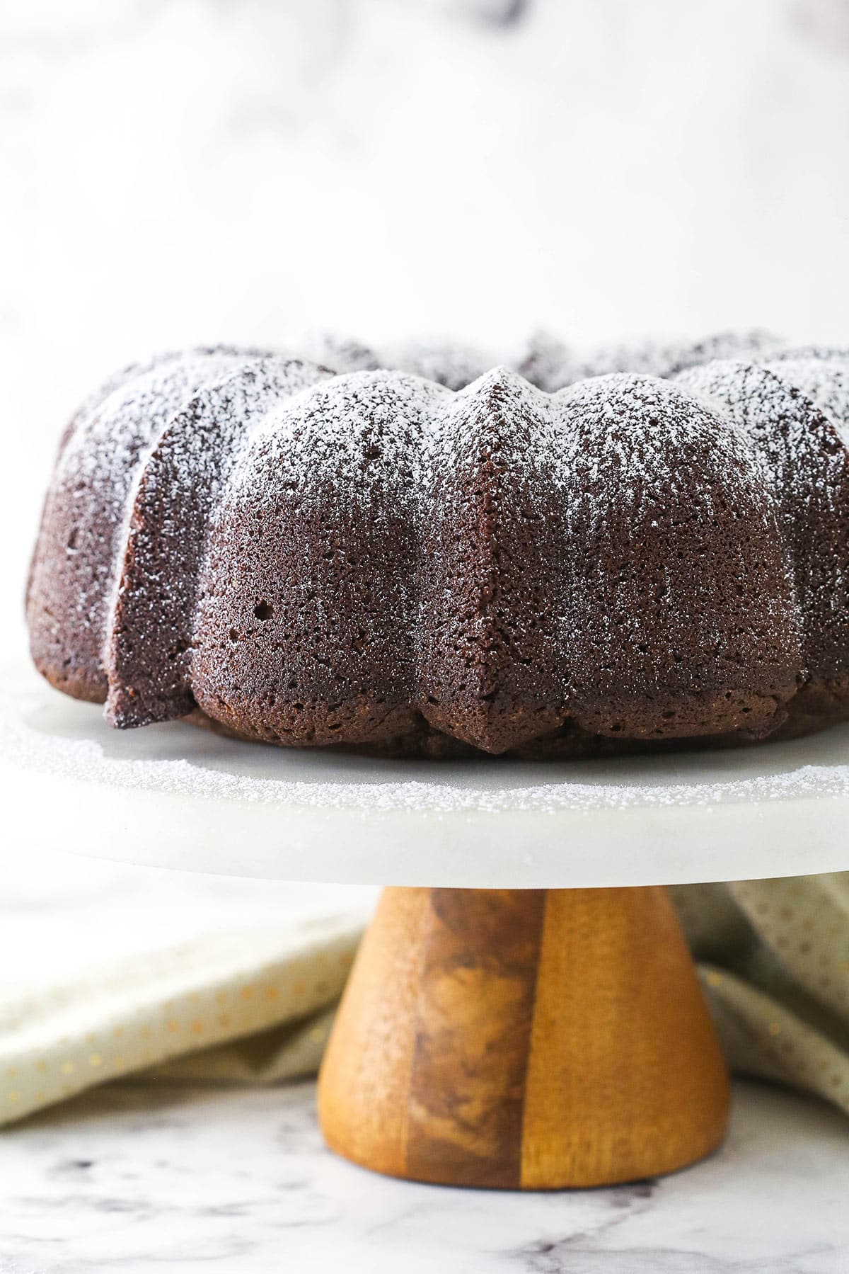 Chocolate pound cake on a cake stand.