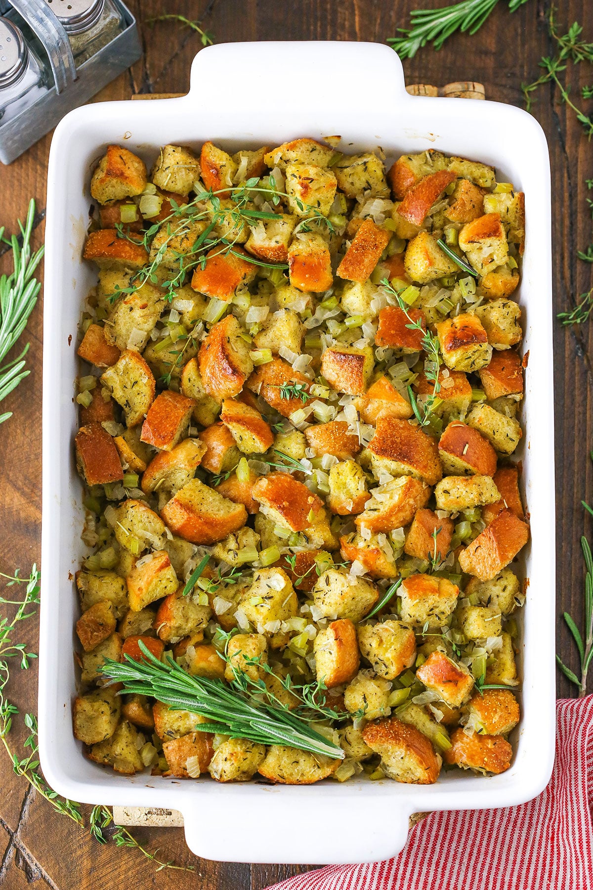 Overhead view of Classic Homemade Stuffing in a white serving platter on a wooden table