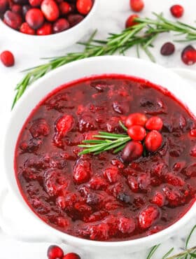 Overhead view of easy homemade Cranberry Sauce in a white bowl on a white table