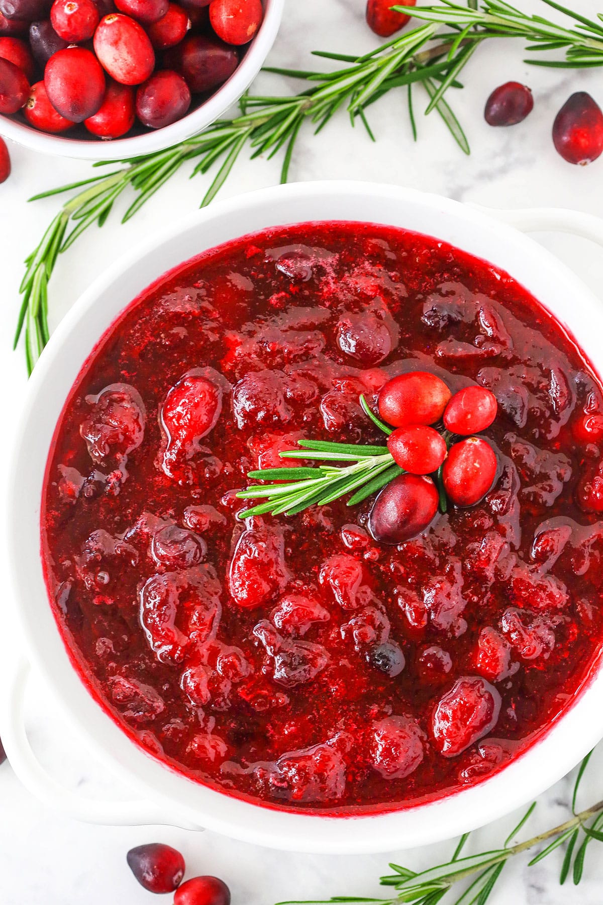 Overhead view of easy homemade Cranberry Sauce in a white bowl on a white table