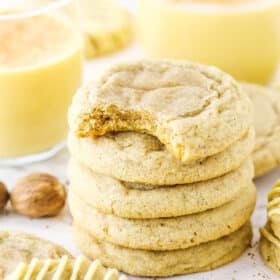 Five Eggnog Cookies stacked with the top cookie missing a bite