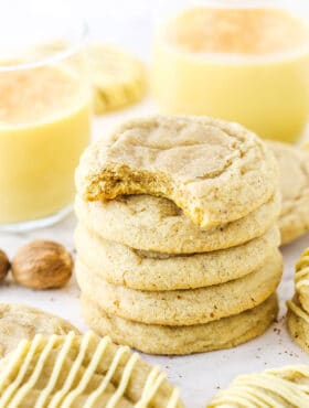 Five Eggnog Cookies stacked with the top cookie missing a bite