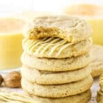 Six Eggnog Cookies stacked with the top cookie missing a bite.