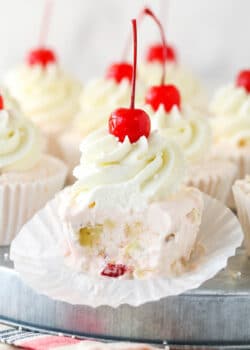 Closeup of a frozen fruit salad cupcake with a bite taken out of it.