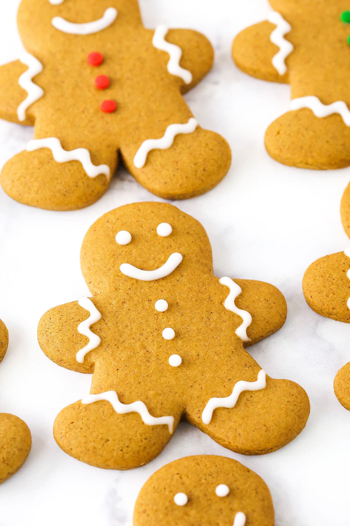 A Gingerbread Cookie decorated with white frosting on a white table