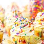 Homemade Funfetti Cupcakes topped with white frosting and colorful sprinkles