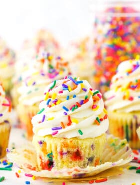 Homemade Funfetti Cupcakes topped with white frosting and colorful sprinkles