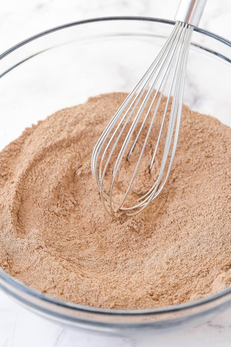 Whisking together dry ingredients for chocolate cake.