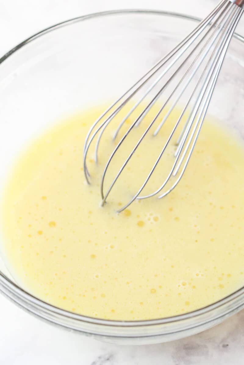 Whisking eggs, milk, and vegetable oil for cake batter.