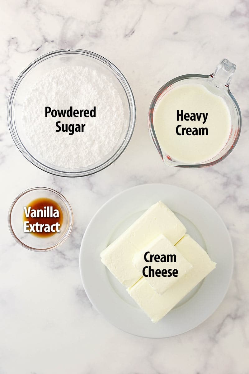 Layers of toasted pecan and coconut loaded cake and a smooth cream cheese frosting come together in this elegant Italian cream cake. Ingredients for Italian cream cake frosting separated into bowls.