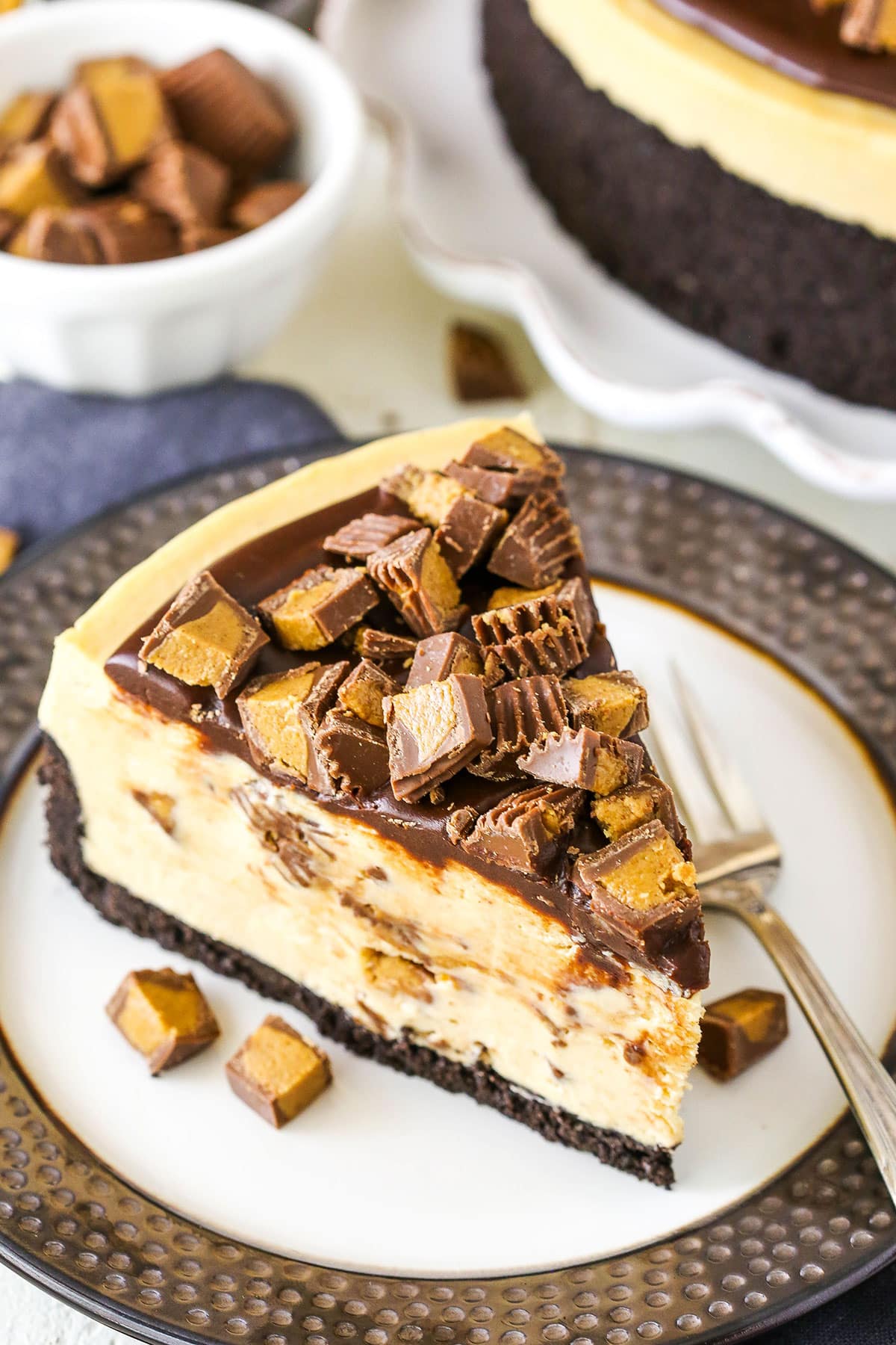 A slice of No Bake Reese's Peanut Butter Cheesecake with a fork on a plate