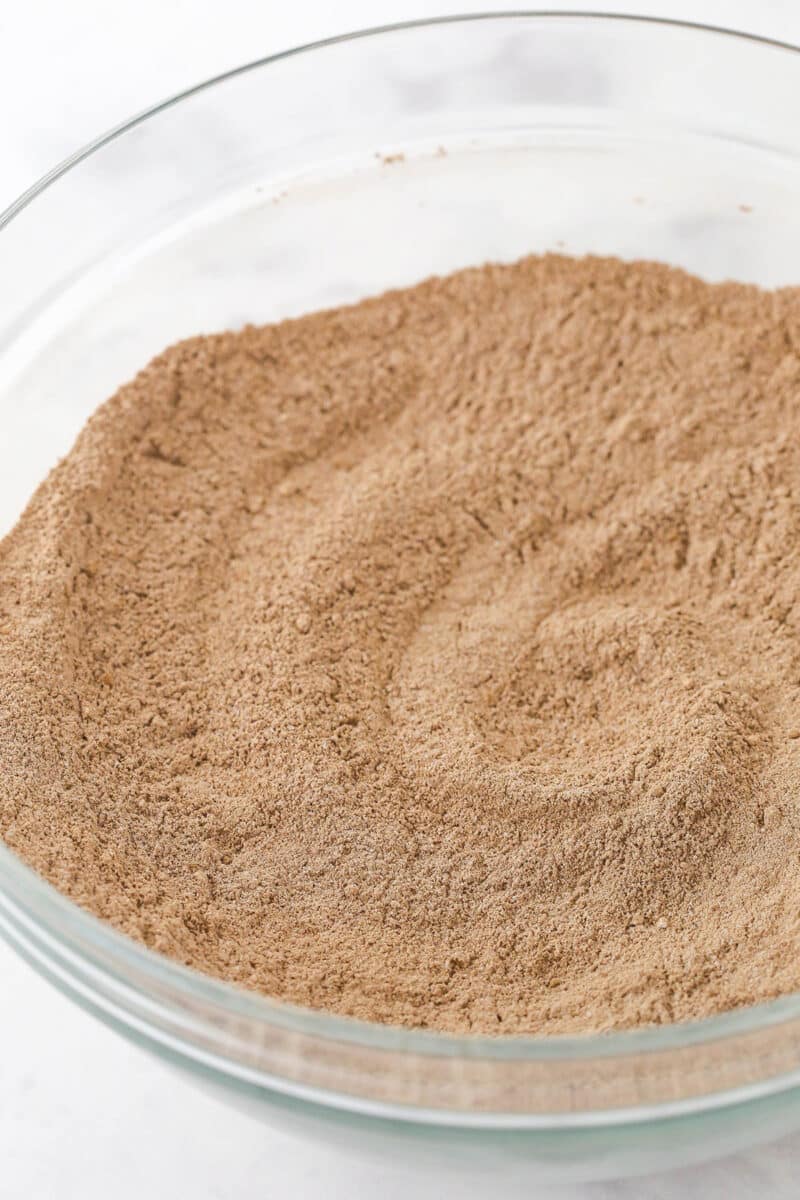 Dry ingredients for chocolate cake batter in a mixing bowl.