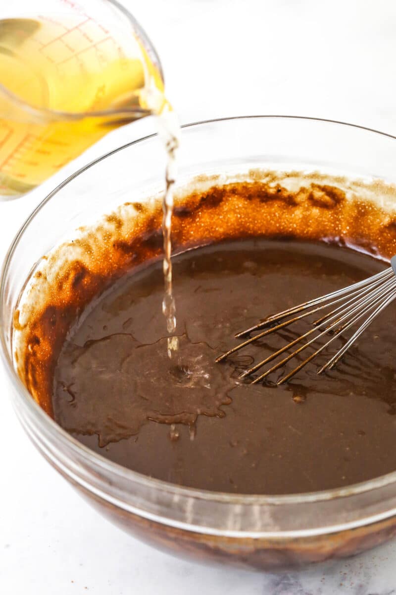 Adding hot water to chocolate cake batter.