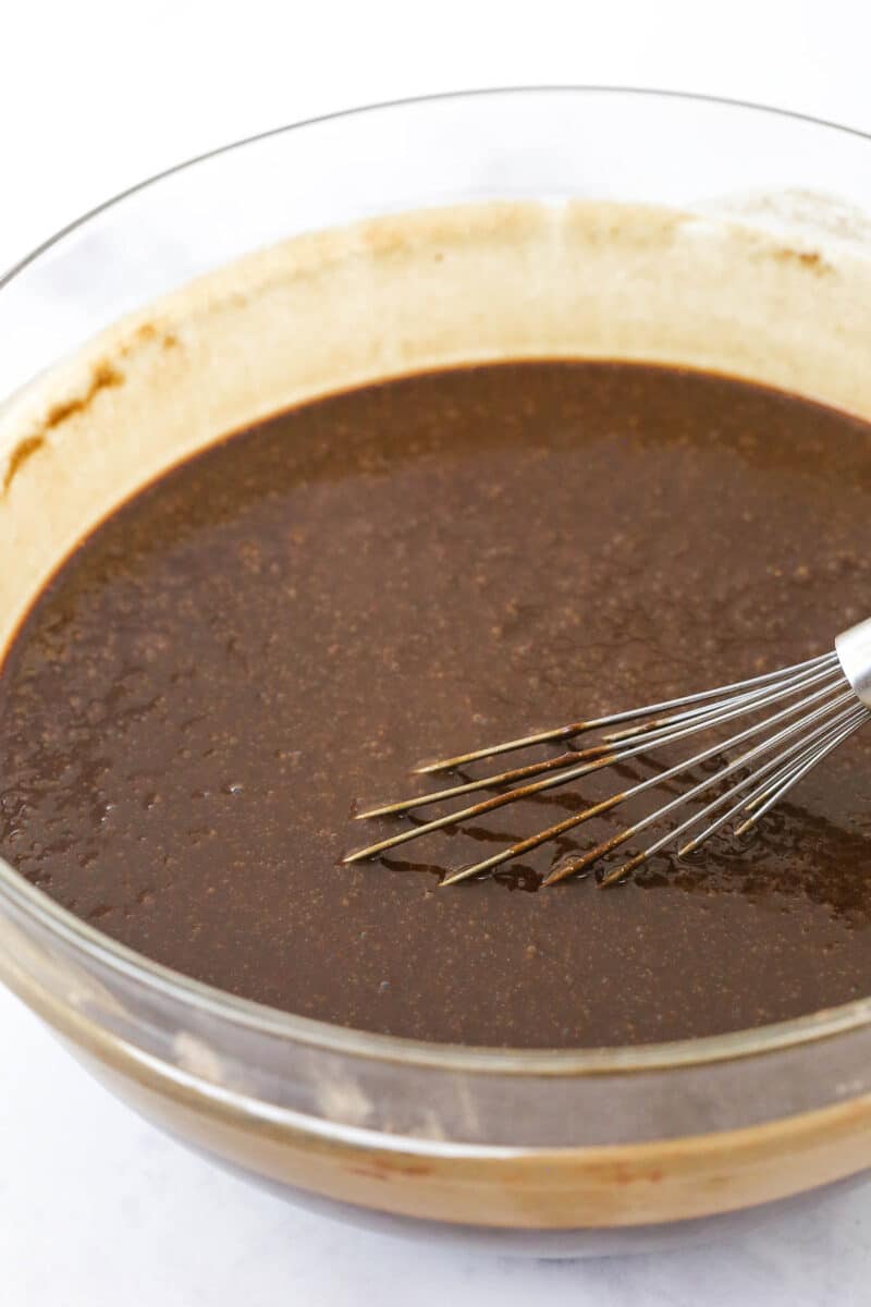 Whisking chocolate cake batter in a mixing bowl.