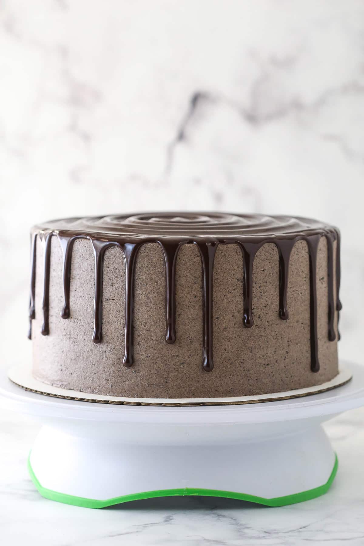 An Oreo cake drizzled with chocolate ganache.