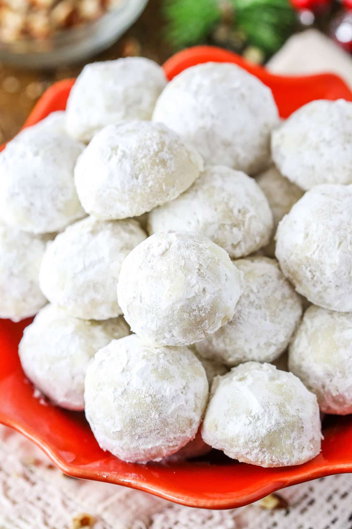 Overhead view of Russian Tea Cakes stacked in a red platter