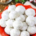 Overhead view of Russian Tea Cakes stacked in a red platter