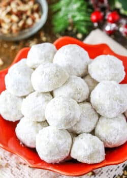 Overhead view of Russian Tea Cakes stacked in a red platter