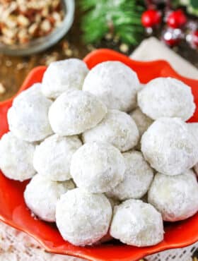 Overhead view of Russian Tea Cakes stacked in a red platter