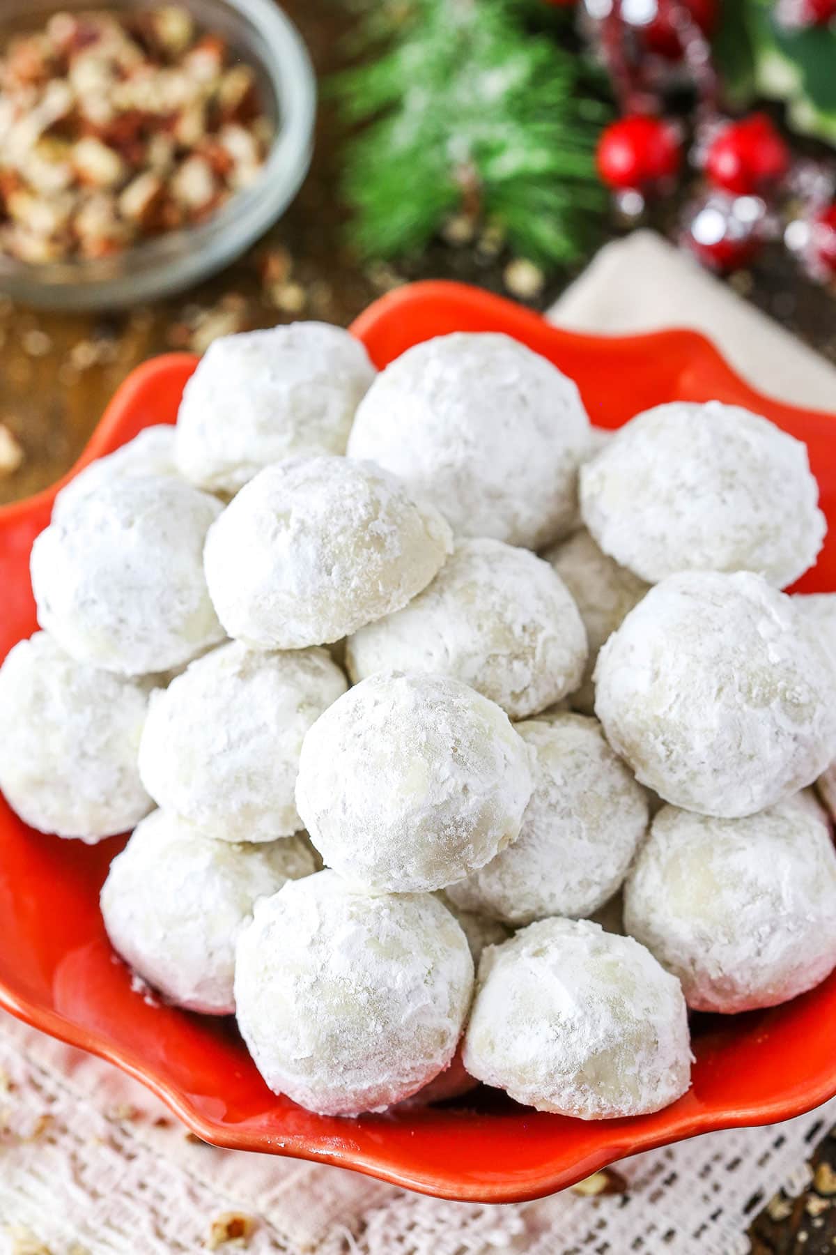 Overhead view of Russian Tea Cakes stacked in a red platter