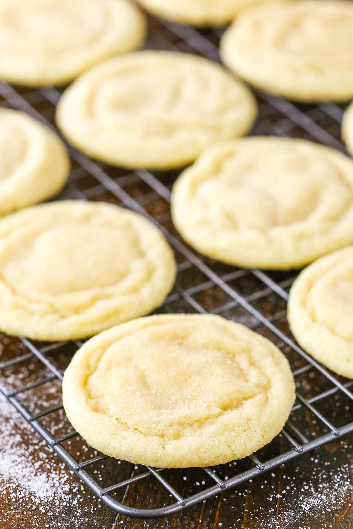 Sugar Cookies spread out on a metal cooling rack