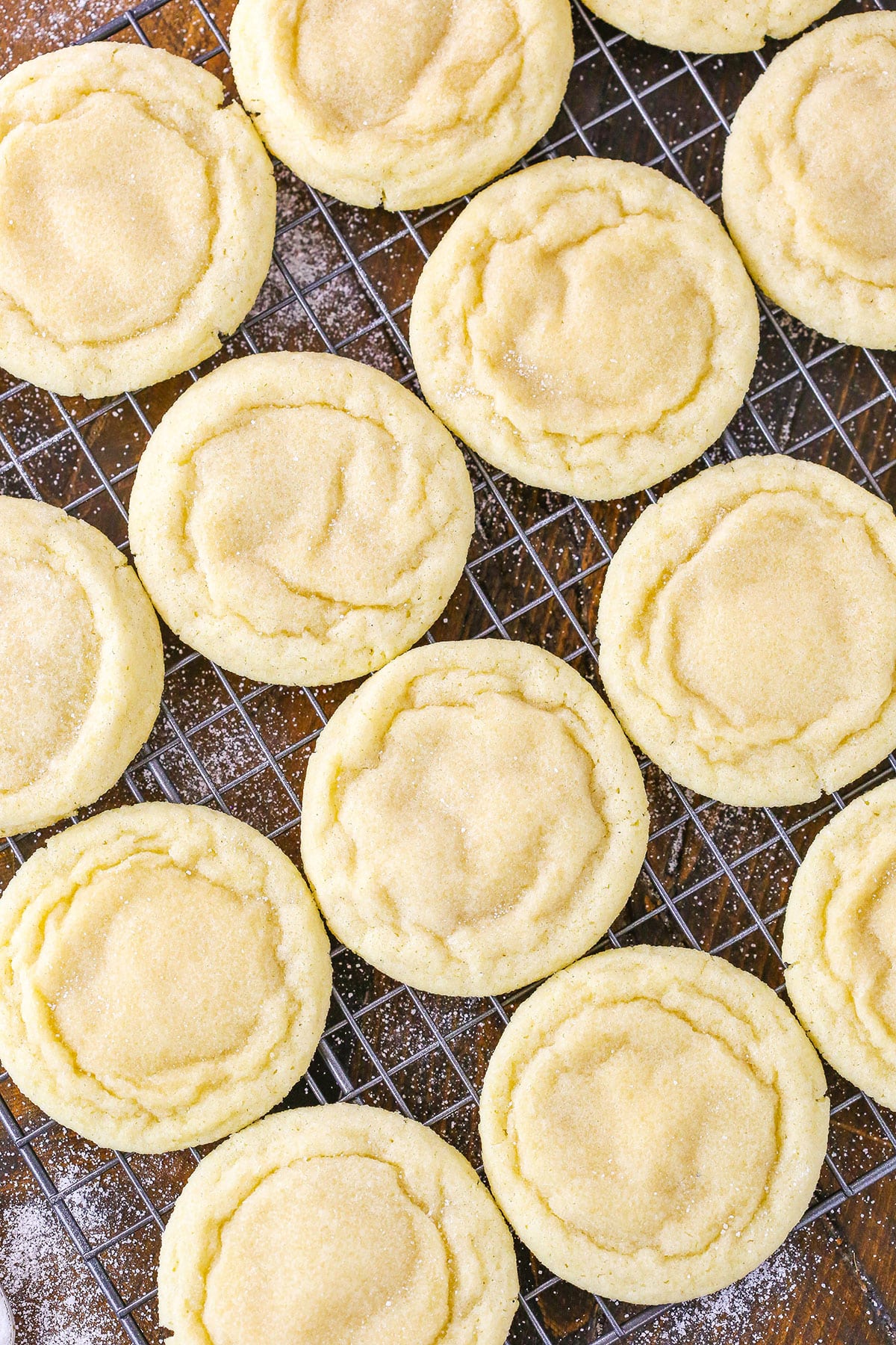 Sugar Cookies spread out on a metal cooling rack