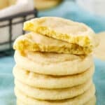 Six Sugar Cookies stacked with the top Sugar Cookie broken in half