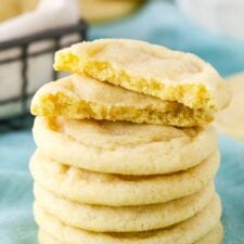 Six Sugar Cookies stacked with the top Sugar Cookie broken in half