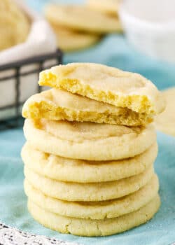 Six Sugar Cookies stacked with the top Sugar Cookie broken in half