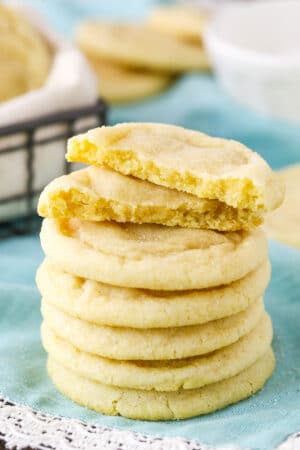 Six Sugar Cookies stacked with the top Sugar Cookie broken in half