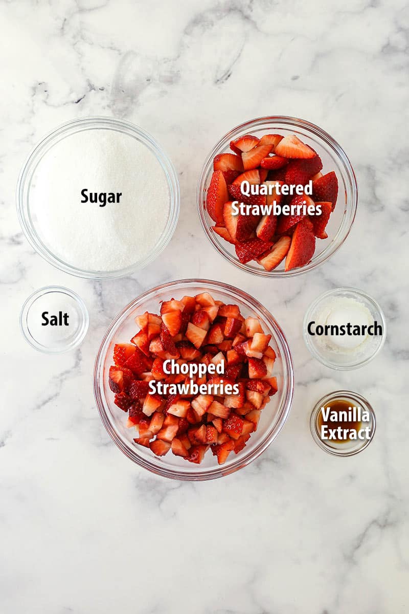 strawberry cheesecake topping ingredients on marble background