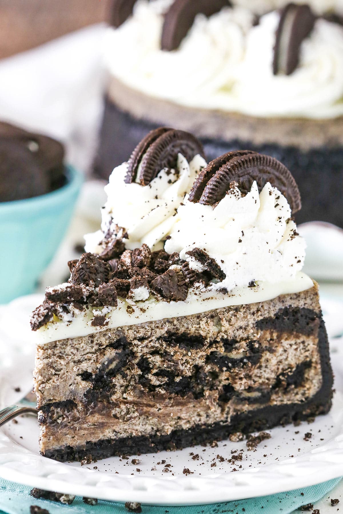 A slice of the BEST Oreo cheesecake on a plate.