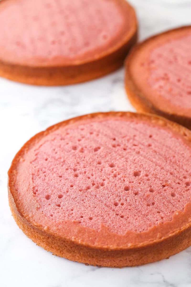 Three layers of strawberry cake before stacking and frosting.