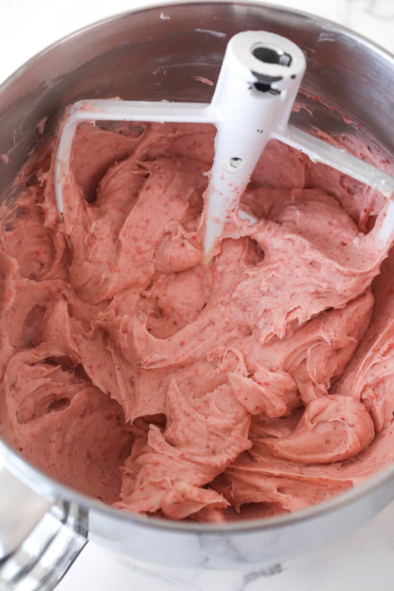 Strawberry frosting in a mixing bowl.