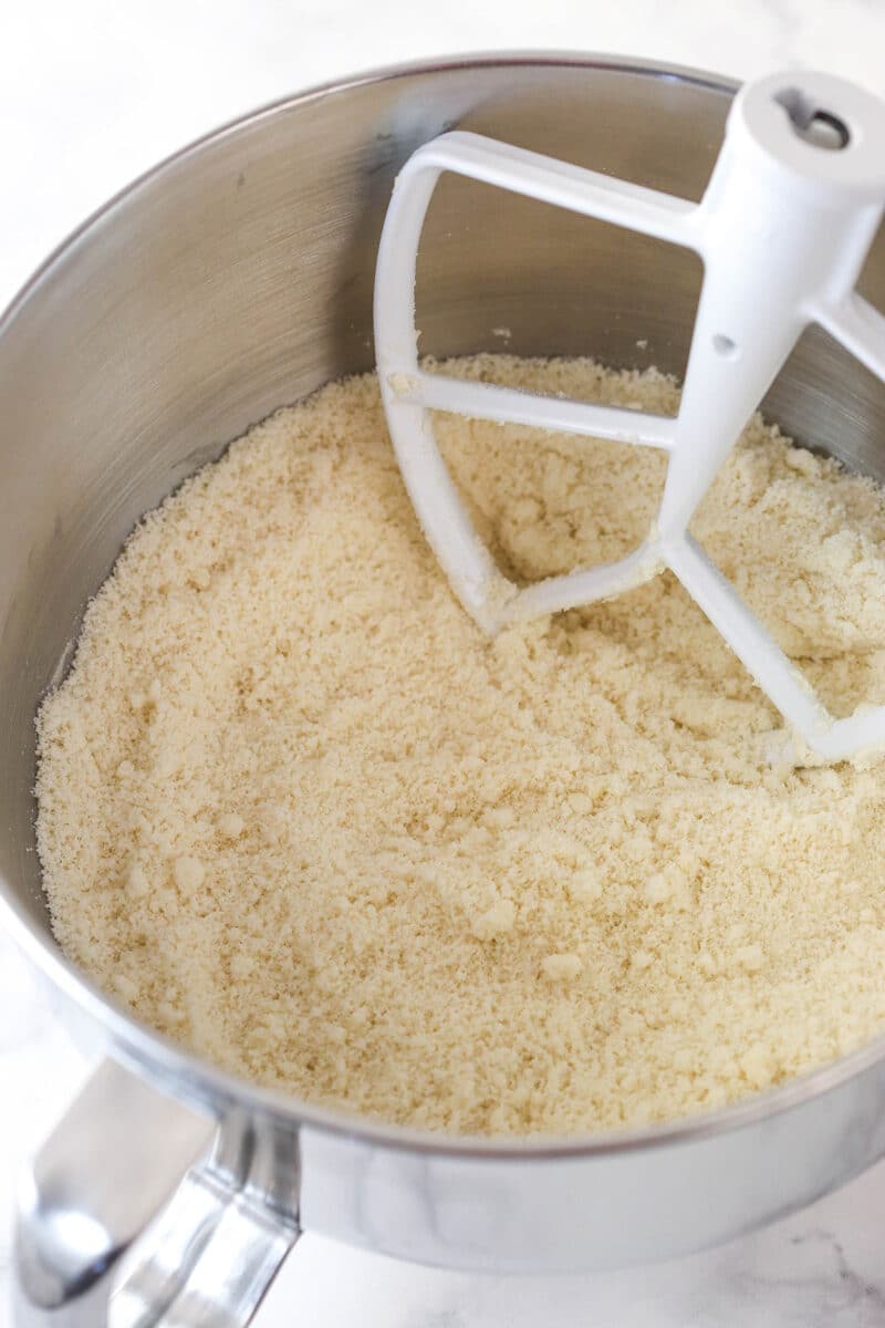 Mixing butter into dry ingredients for cake batter (reverse creaming method).