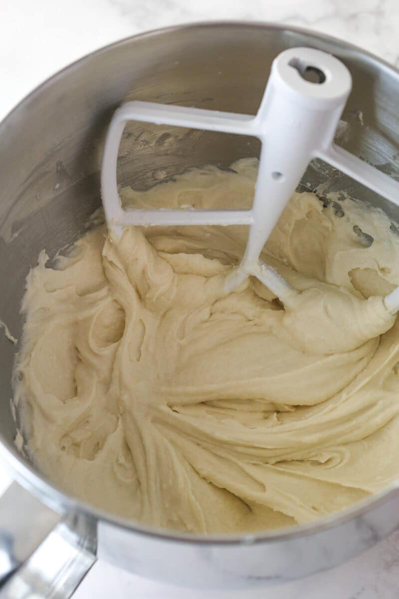 Adding dry ingredients and milk to wet ingredients for cupcake batter.