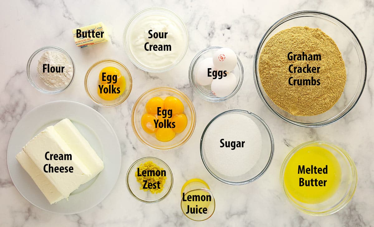 Ingredients for lemon cheesecake separated into bowls.