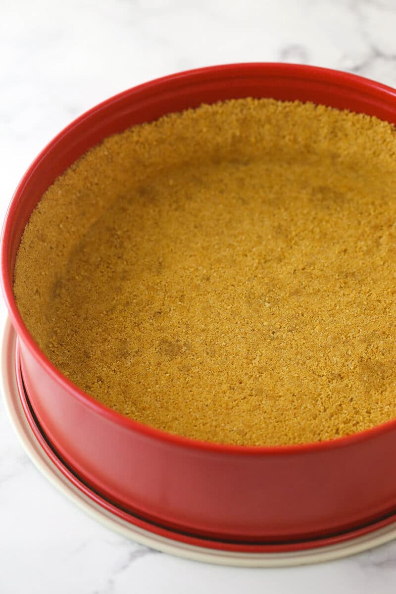 Graham cracker crust baked into a springform pan.