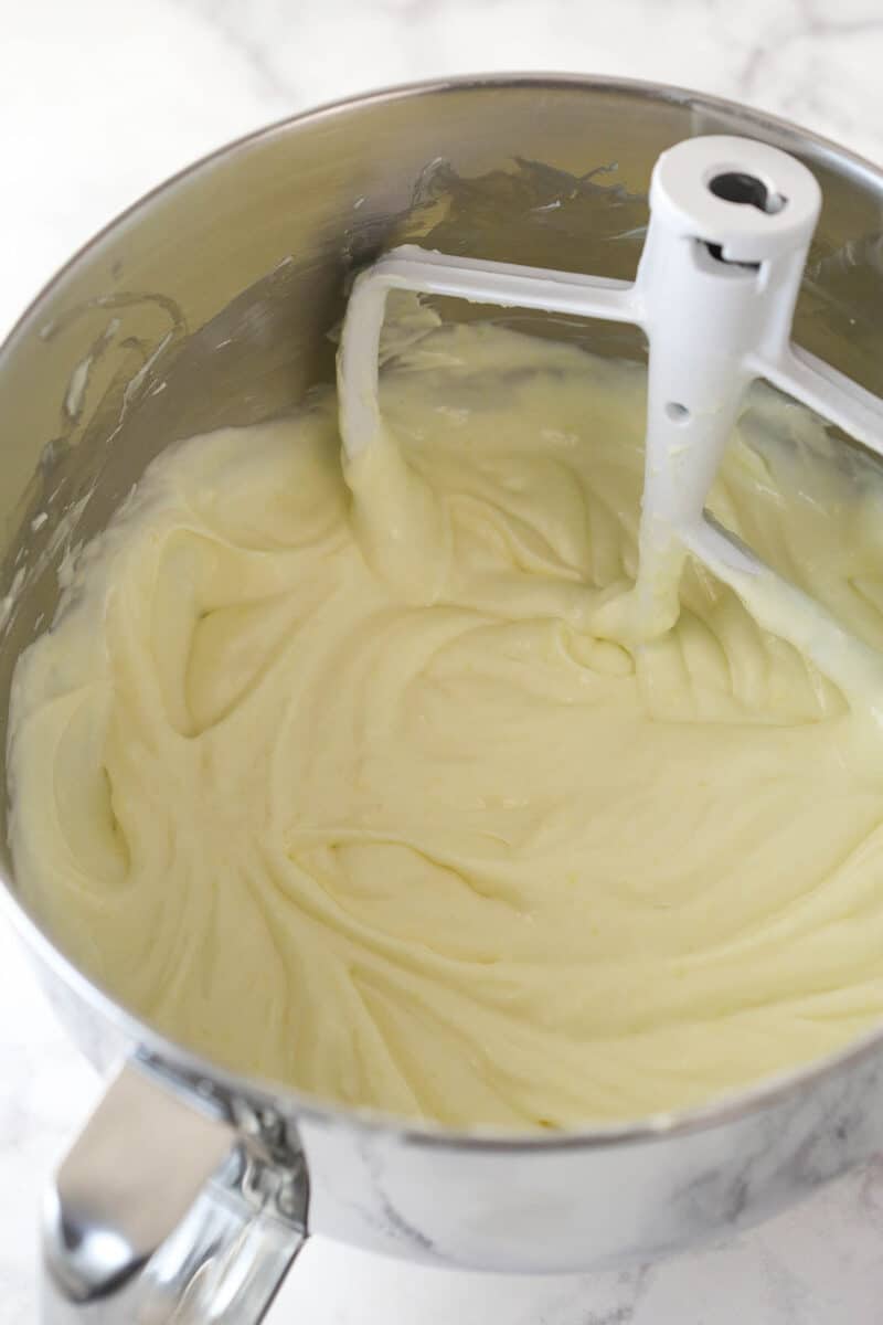 Adding sour cream, lemon juice, and lemon zest to cheesecake filling.