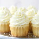 White cupcakes on a serving tray.