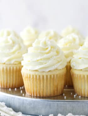 White cupcakes on a serving tray.