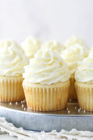 White cupcakes on a serving tray.